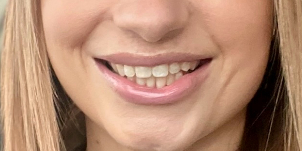 a close up of a woman with pink hair looking at the camera